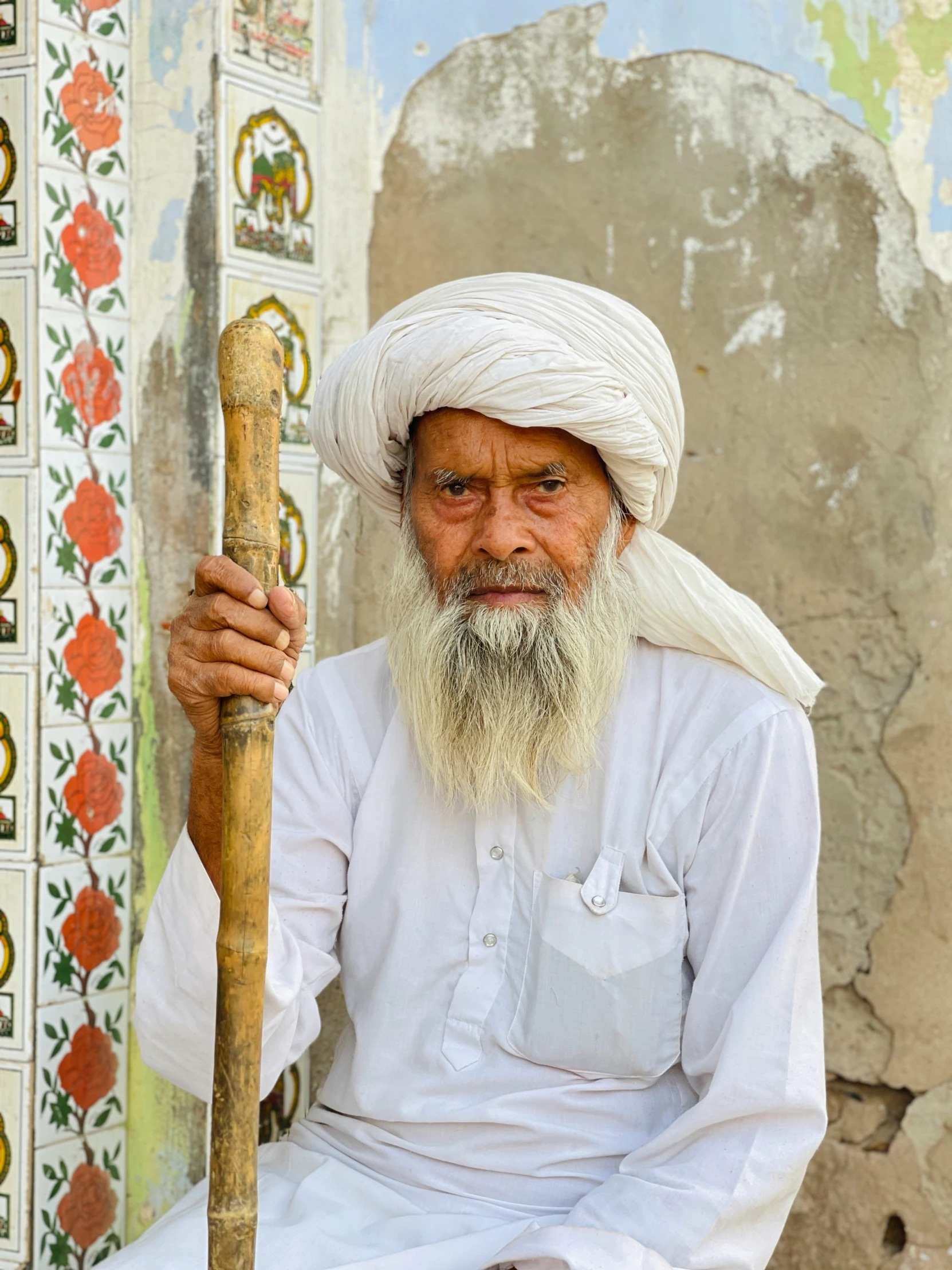 a man with white turban sitting down