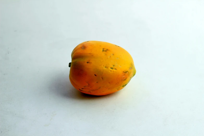 an orange is sitting alone on a table