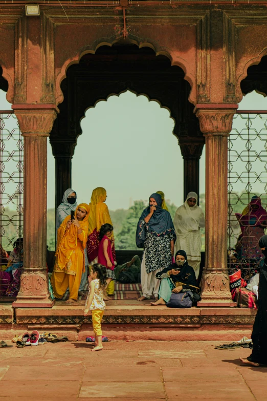 several women in a courtyard near some people