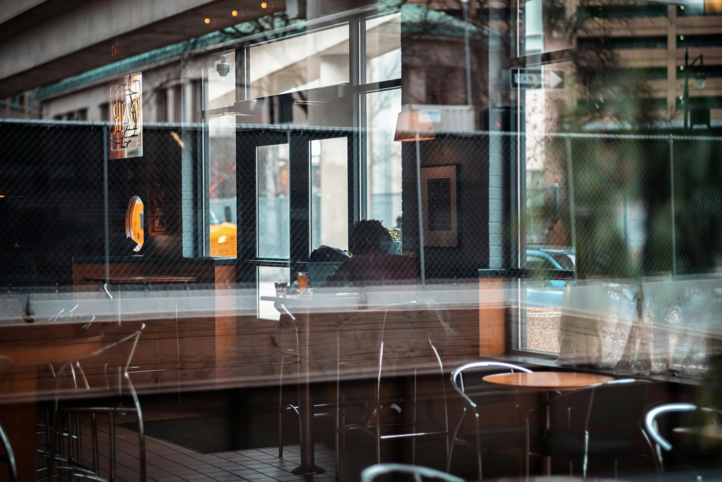 tables sit outside in a large glass walled area