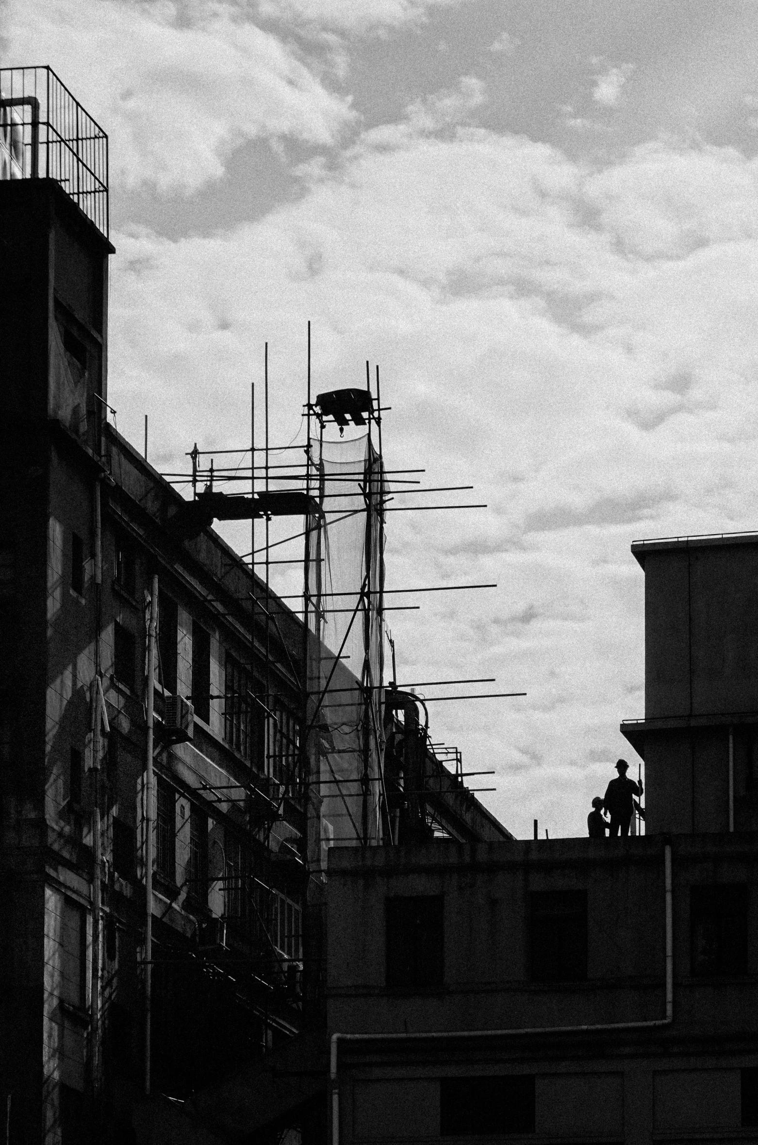 two buildings and a cloudy sky above them