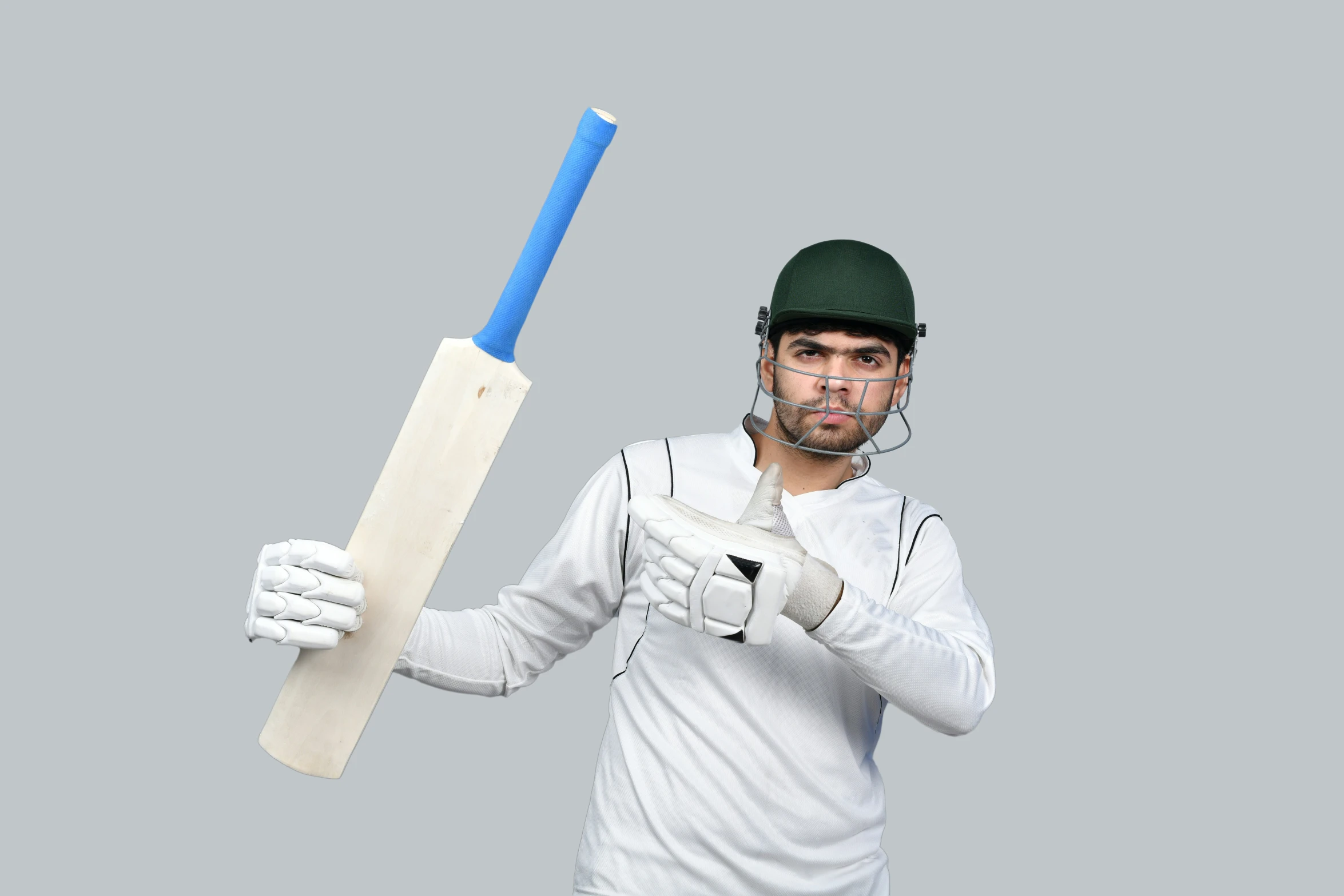 a man holding a cricket bat in one hand