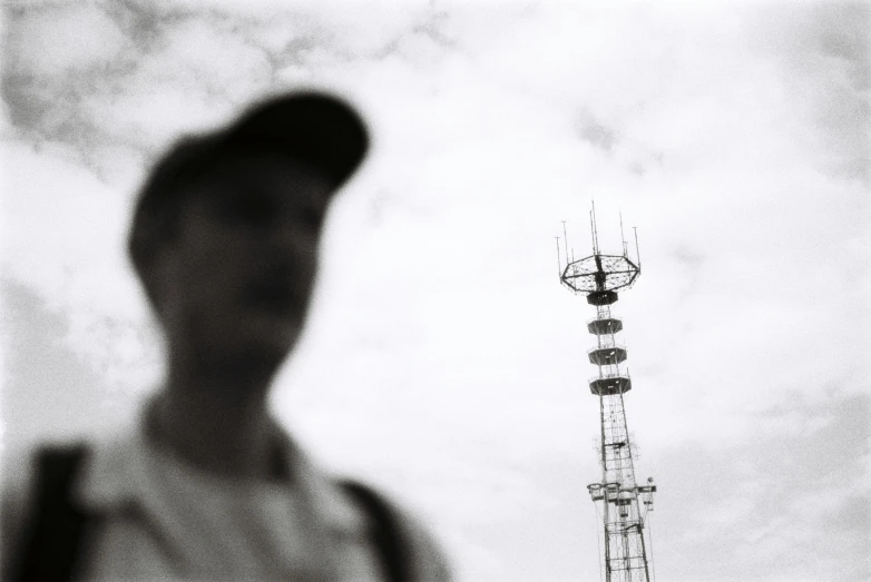 the silhouette of a man is shown behind a radio tower