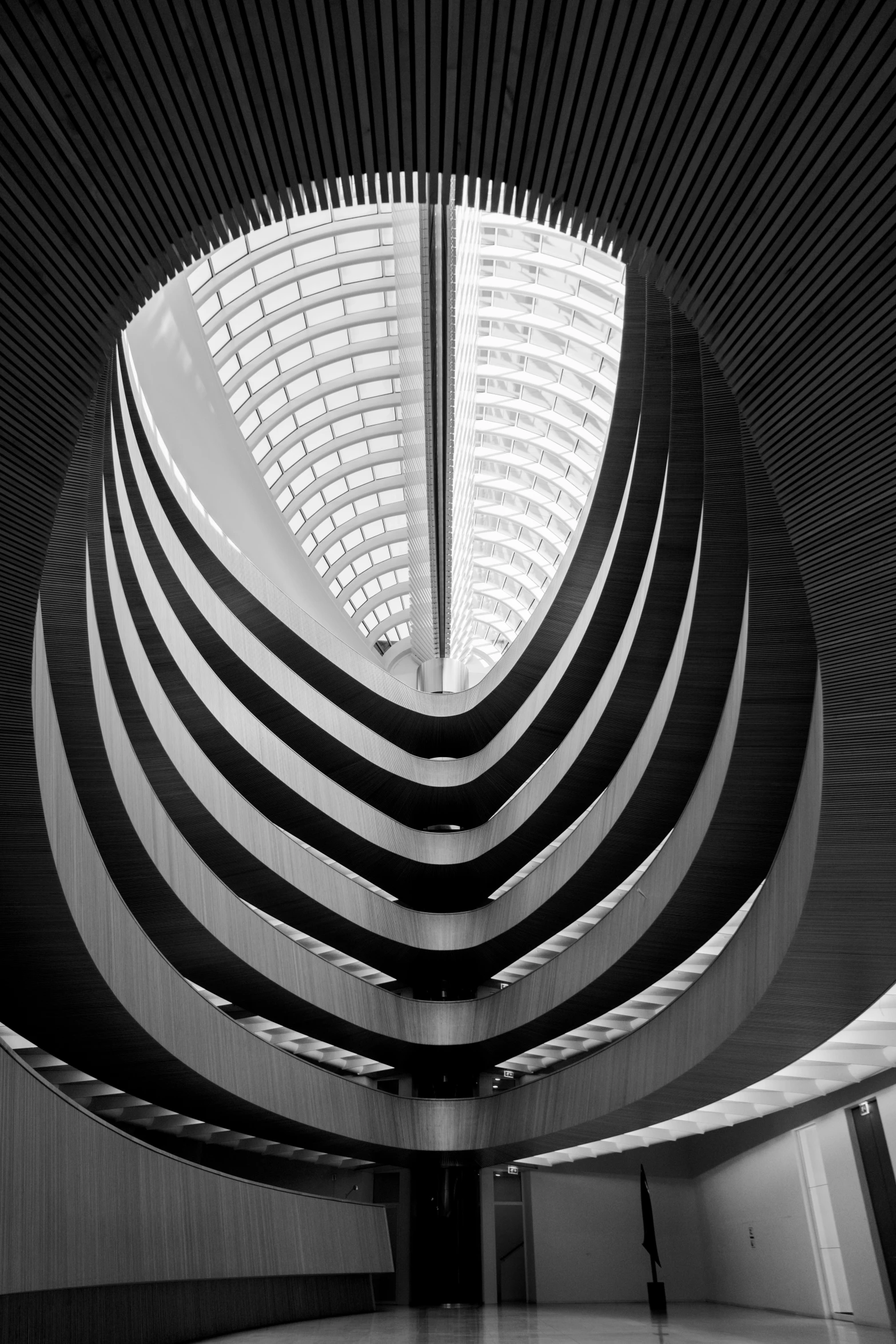 the interior of an enormous building with lots of windows