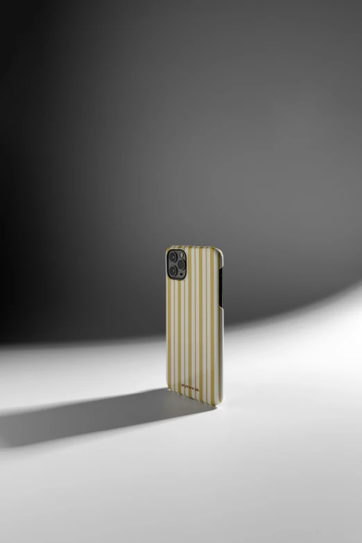 a cellphone sitting in the middle of a striped case