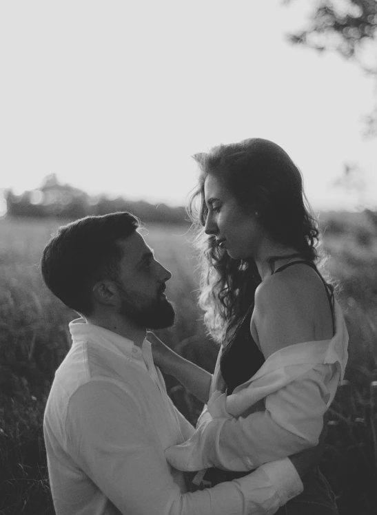 a beautiful young woman sitting on top of a mans chest