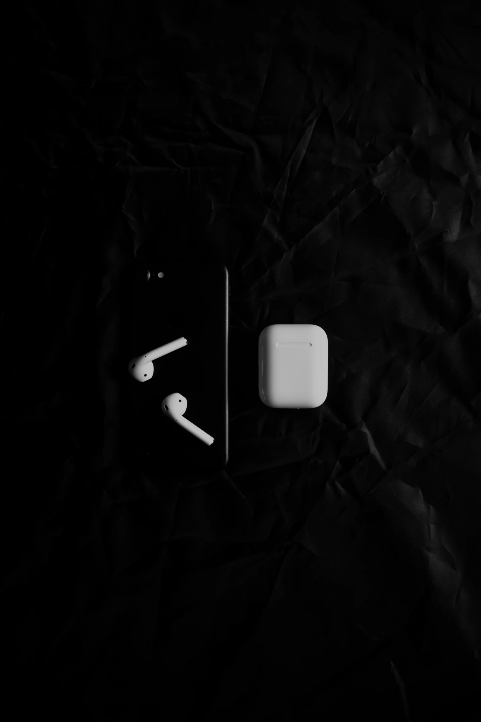 an earphone next to the apple watch face