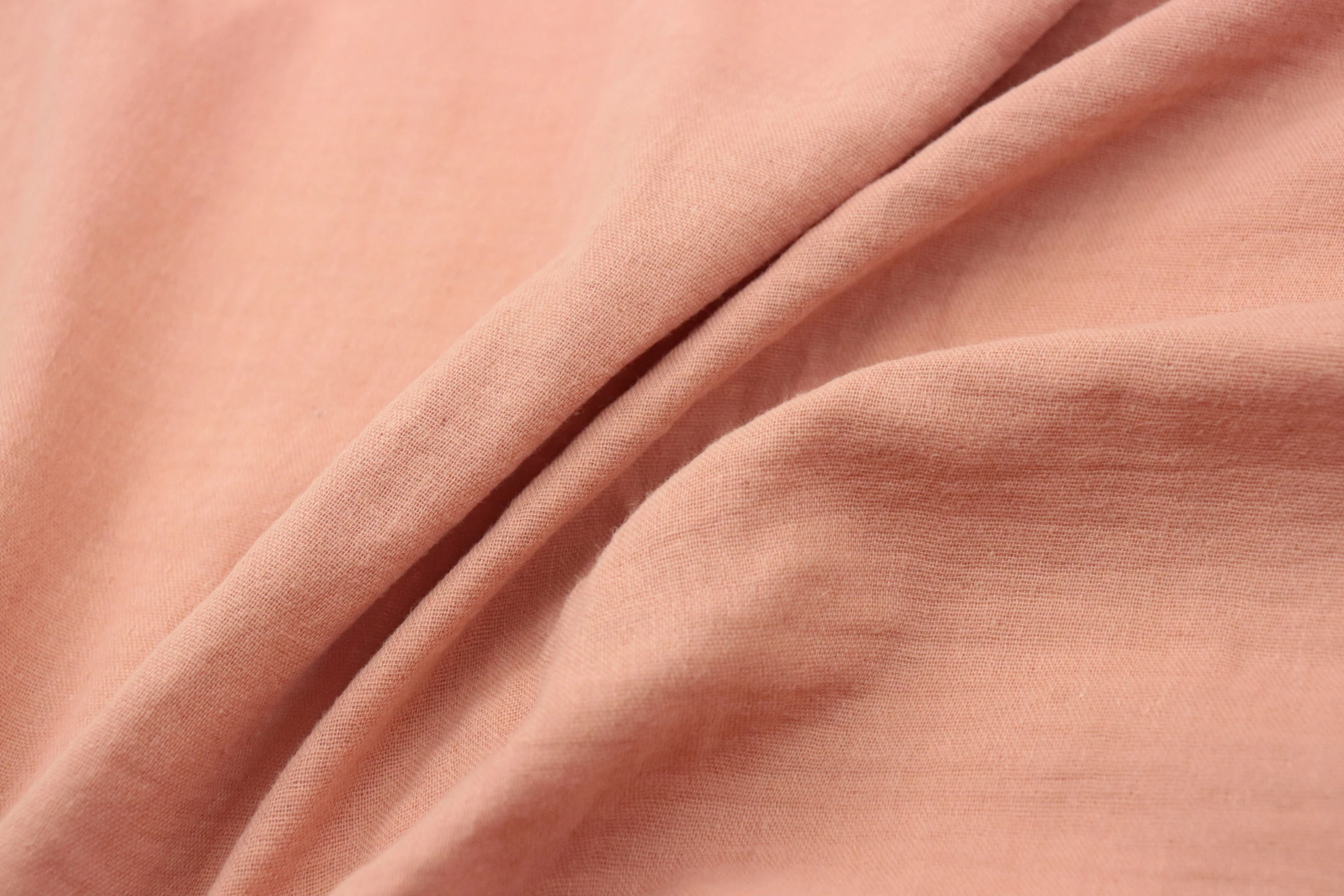 a plain pink fabric closeup showing the folds