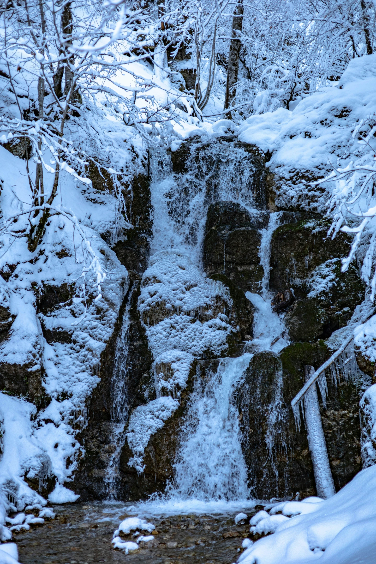 a beautiful view of a waterfall in the winter time