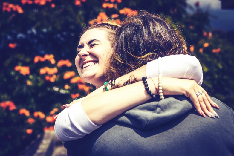 a woman smiling while hugging her boyfriend