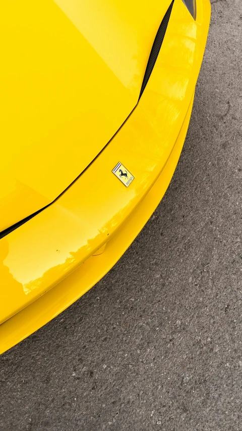 the top of a yellow sports car with metal strip