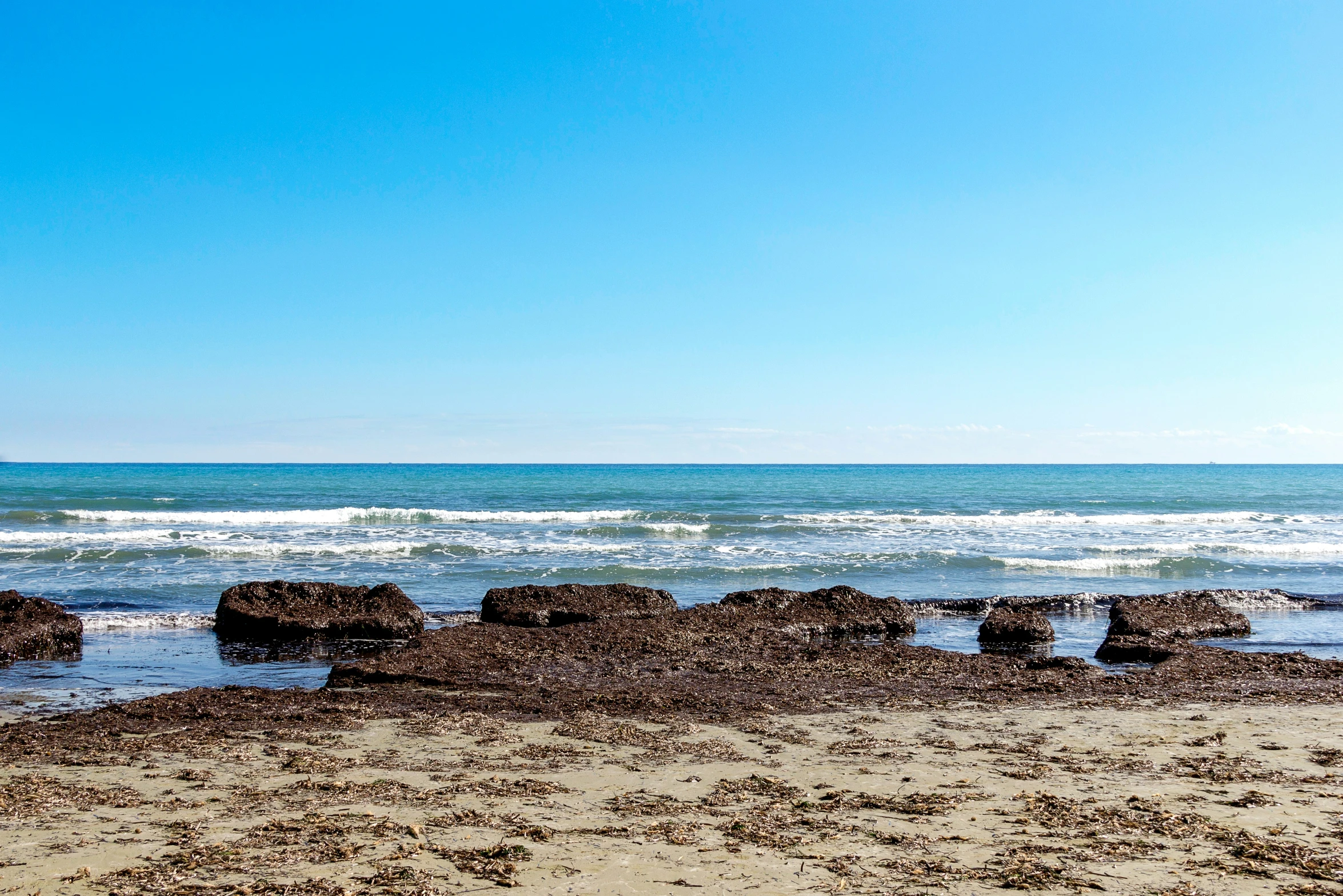 a beach with an ocean view in the background