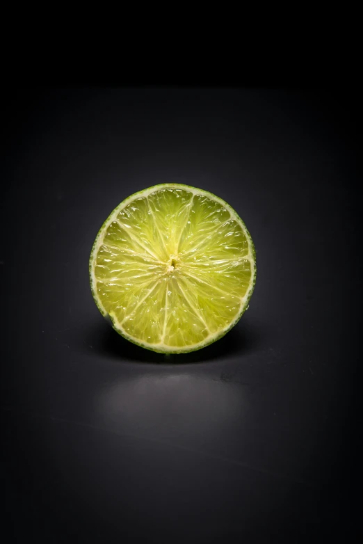 a lime is shown sitting in the dark