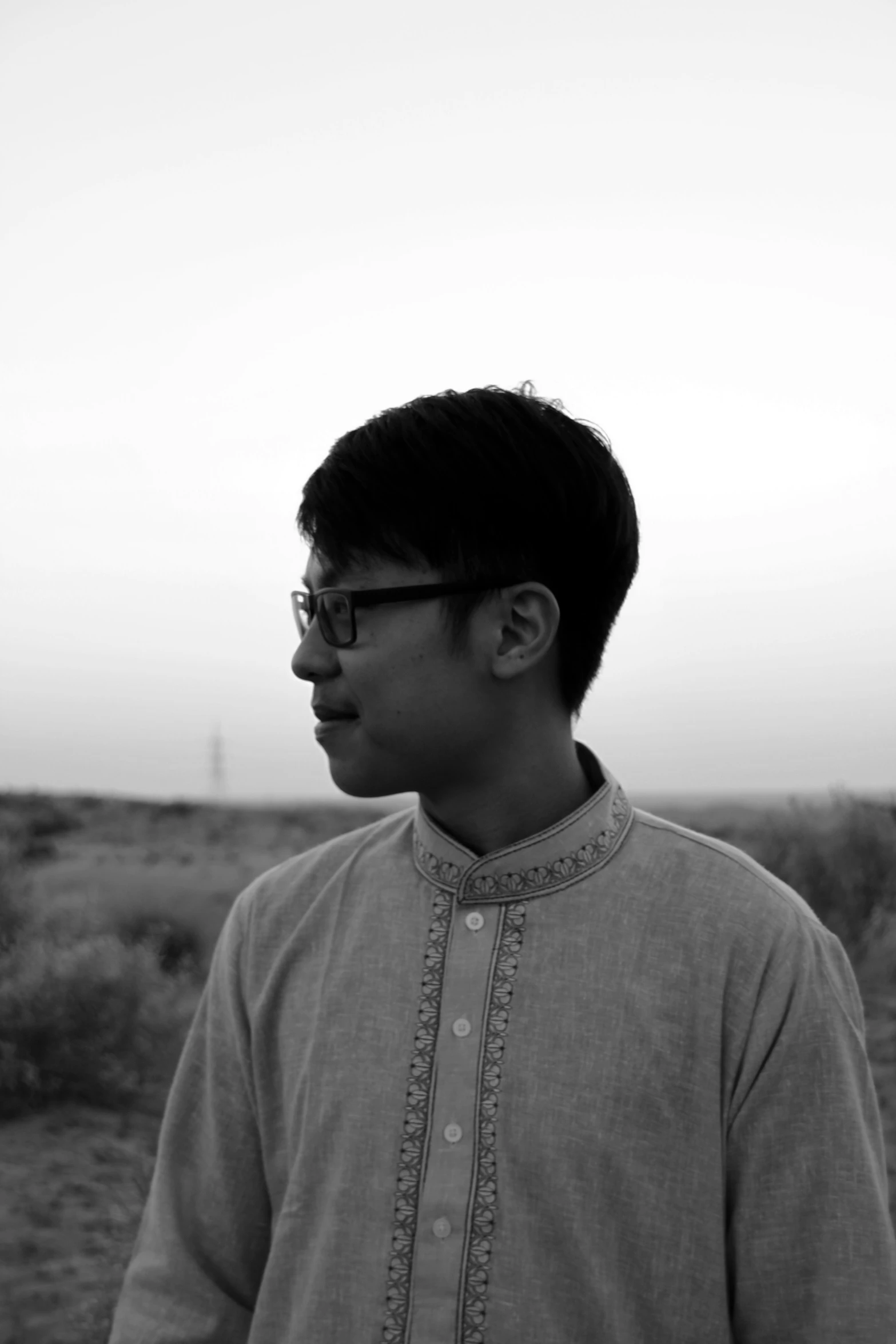 a man standing in a field of dry grass