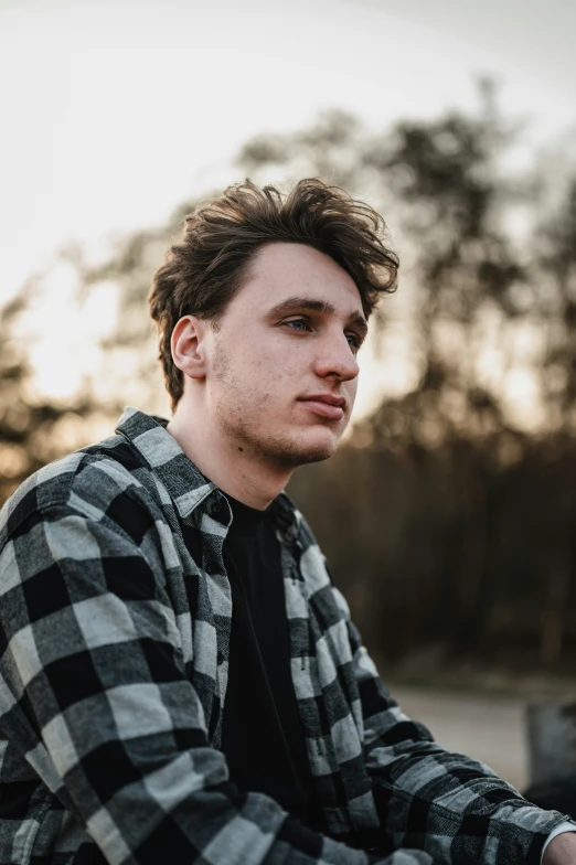 a man in a flannel shirt and tie