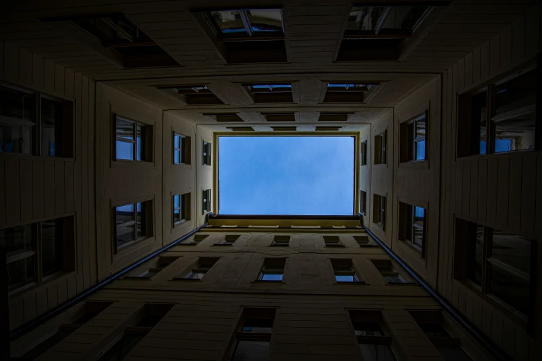 looking down the middle section of an empty room with multiple windows