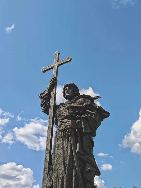 a statue of a woman holding a cross