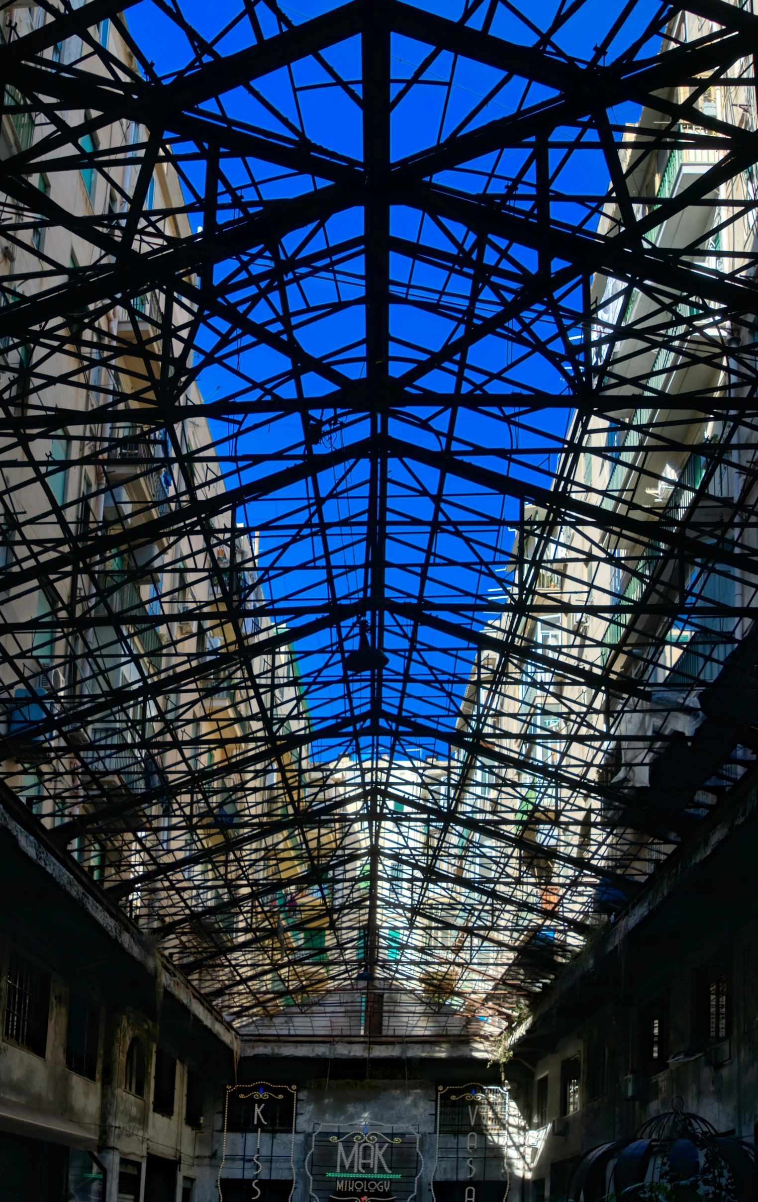 looking up at an empty lobby underneath a clear sky