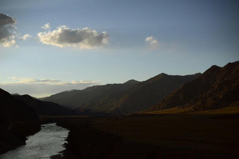 the view is of a river flowing through the valley