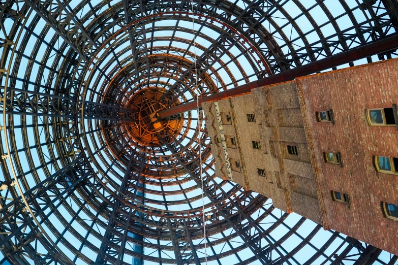 a round clock tower with many windows and an image of a clock on the inside