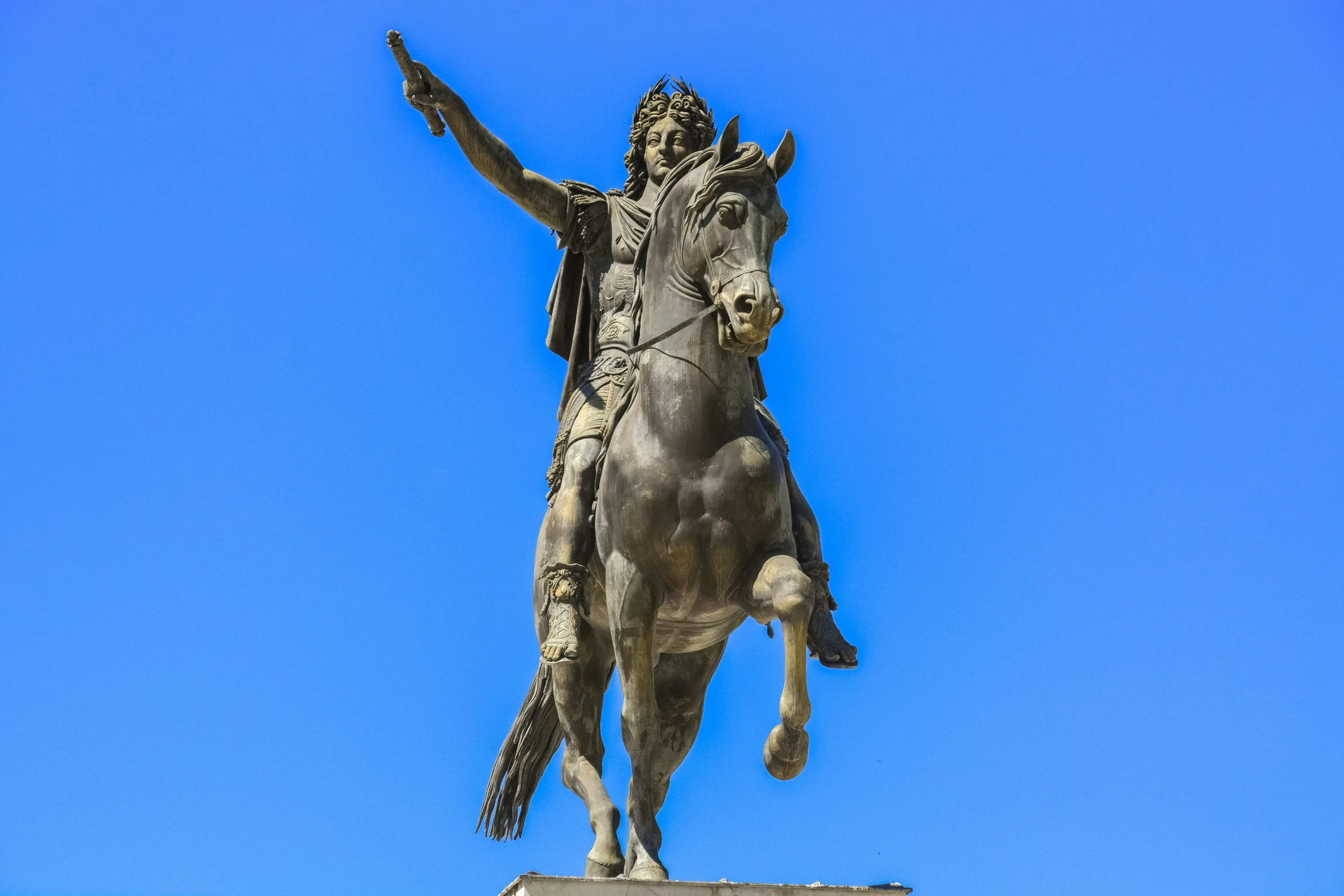 a statue of a man on a horse on a hill