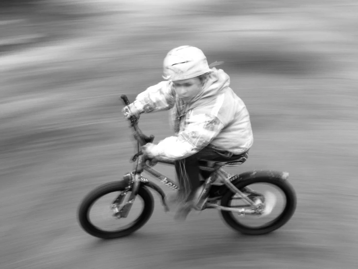 black and white pograph of a  on his bike