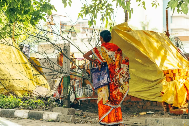 the woman is standing under a yellow cover outside