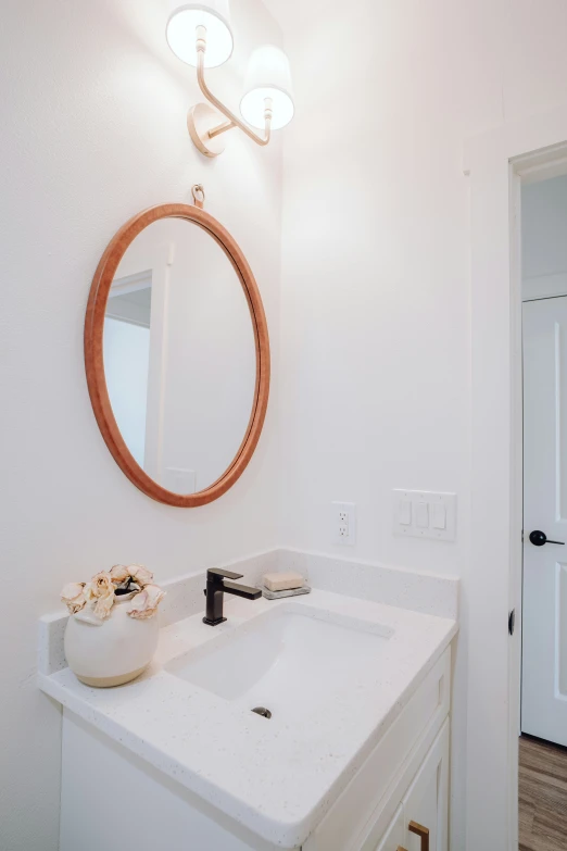 bathroom sink, mirror and door in white and brown tone