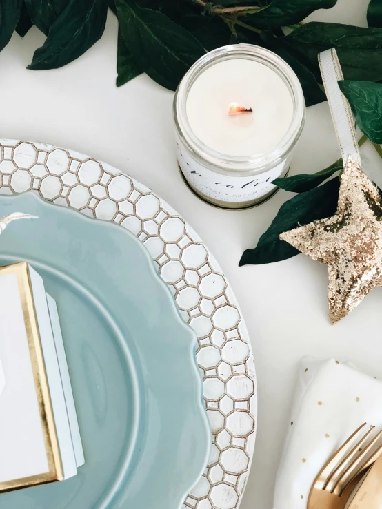 a close up s of table with various place settings, candles, and flowers