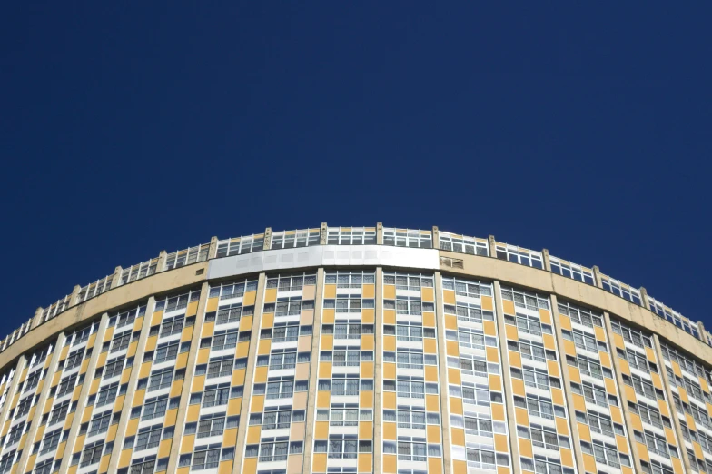 a building with lots of windows and the sky in the background