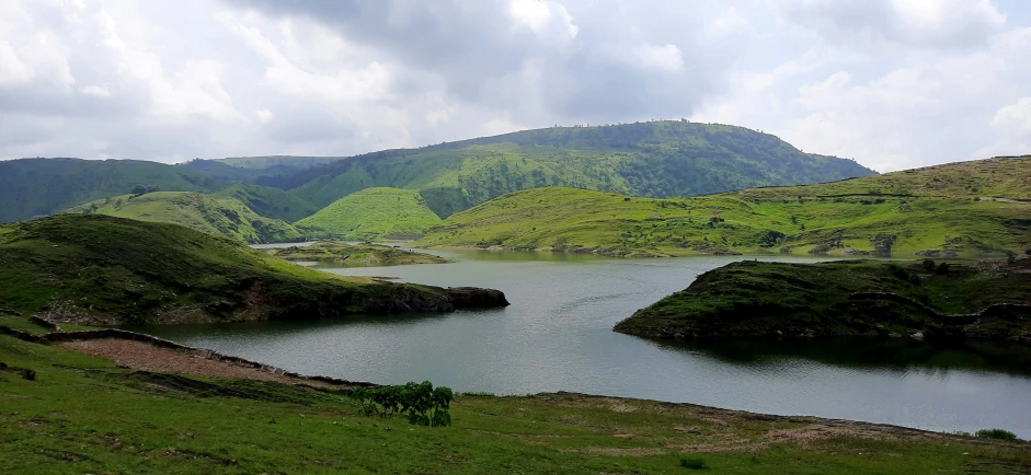 an open field next to some water