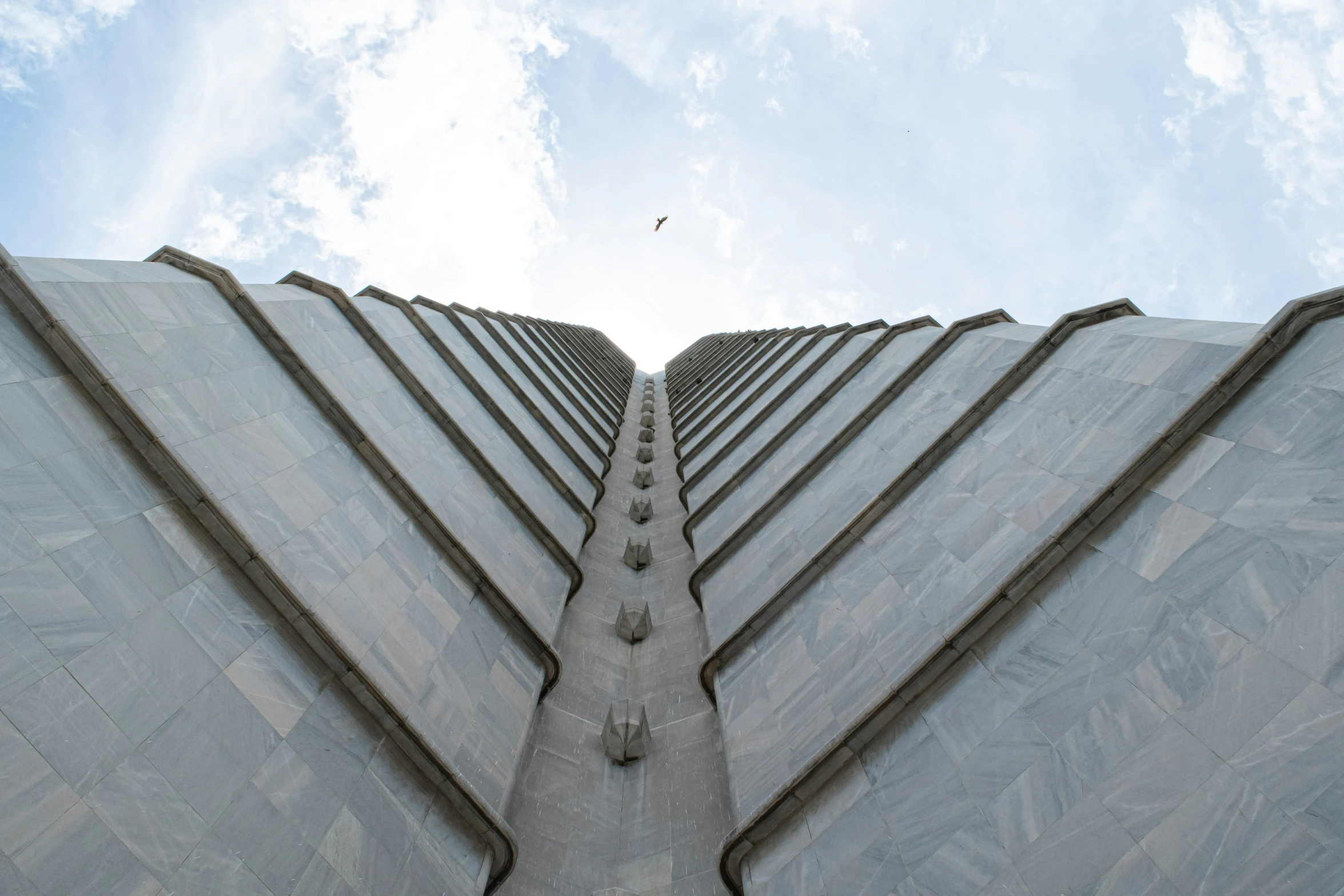 upward view of a concrete sculpture with a sky background