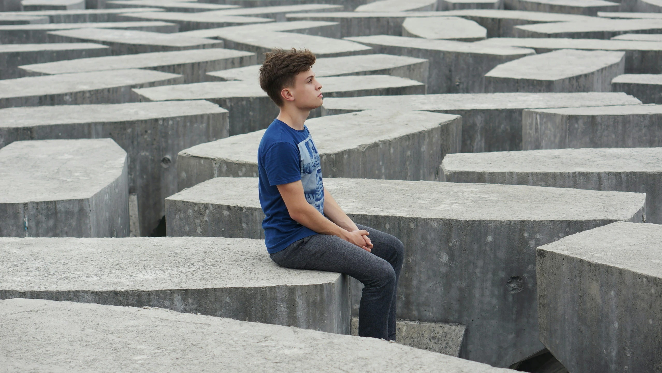 a person sits on top of cement blocks