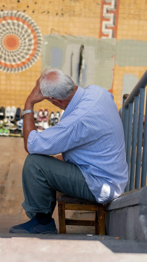 the old man sits alone on his steps