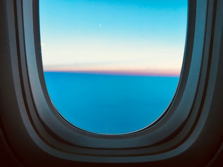 the window of a airplane shows a landscape