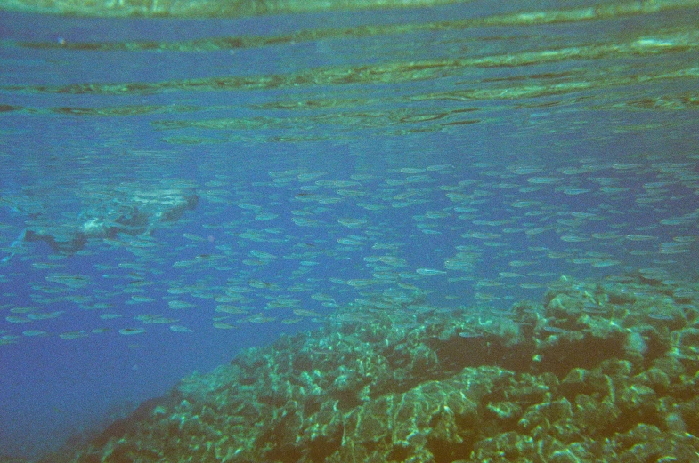 a large ship floating over the ocean under water