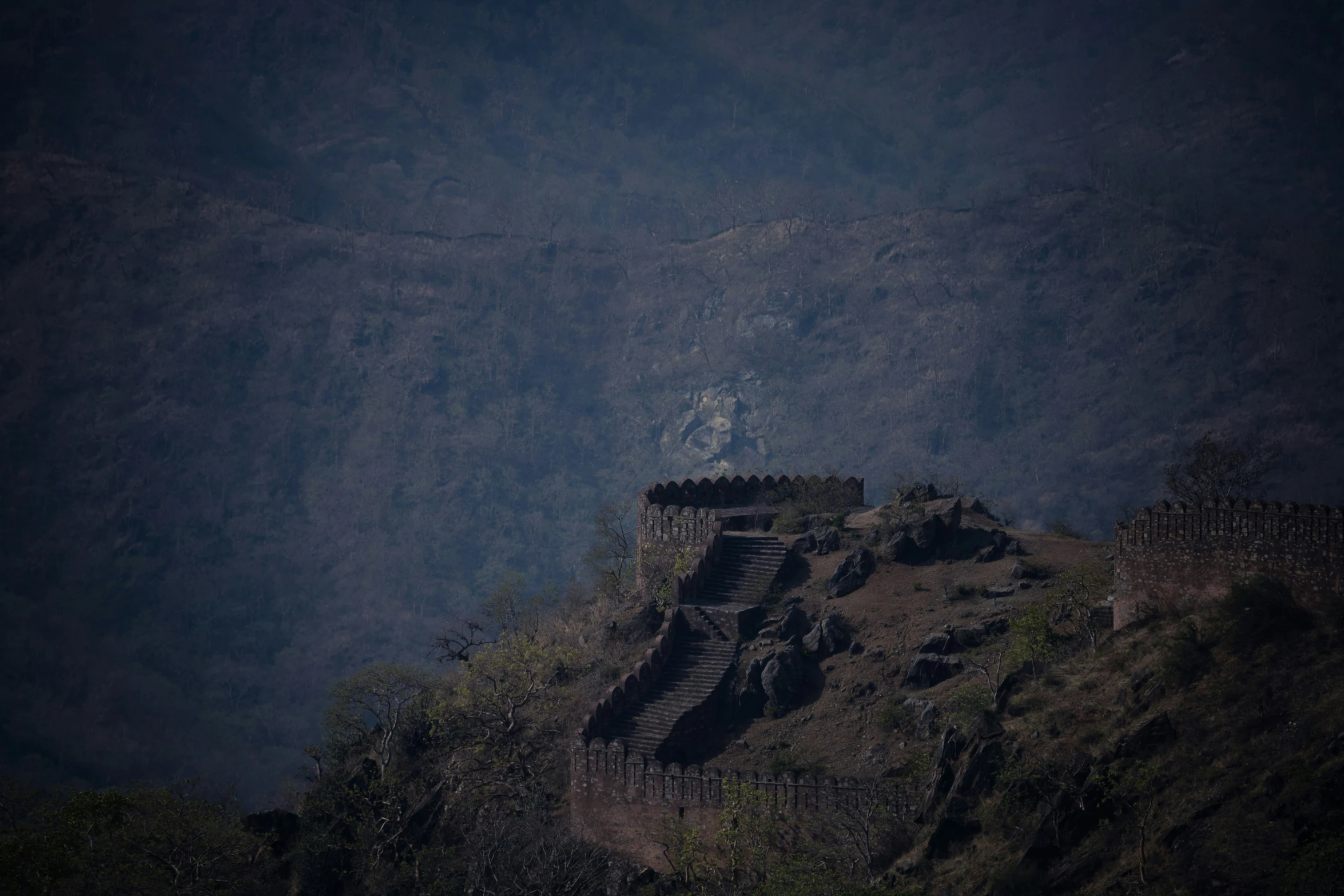 a large tower on the side of a hill