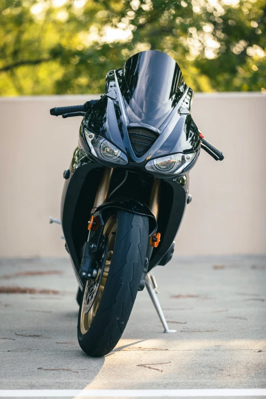 a shiny black motorcycle parked in a parking lot