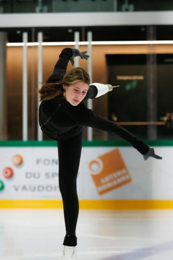 a skater performs in an indoor skating rink
