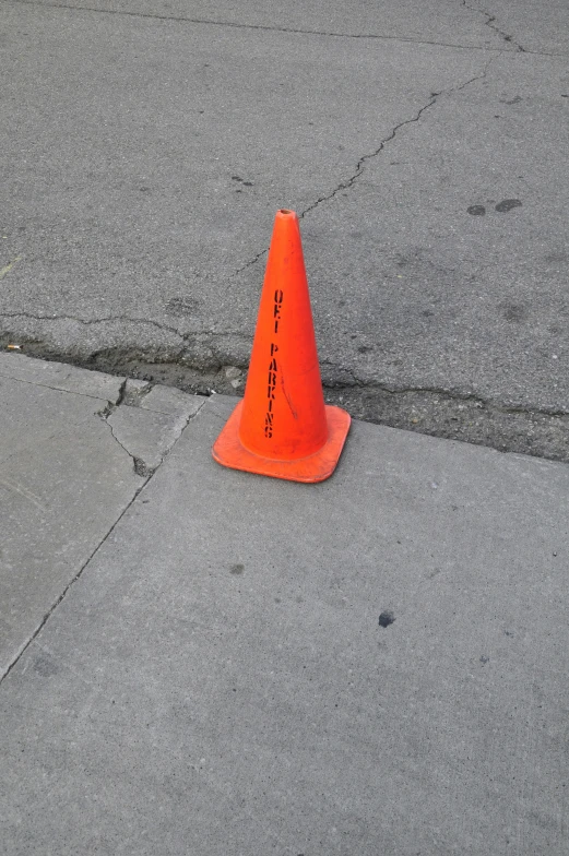 a traffic cone sitting on the corner of a street