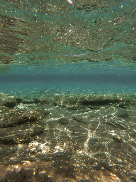 view of ocean water under a surface of sand