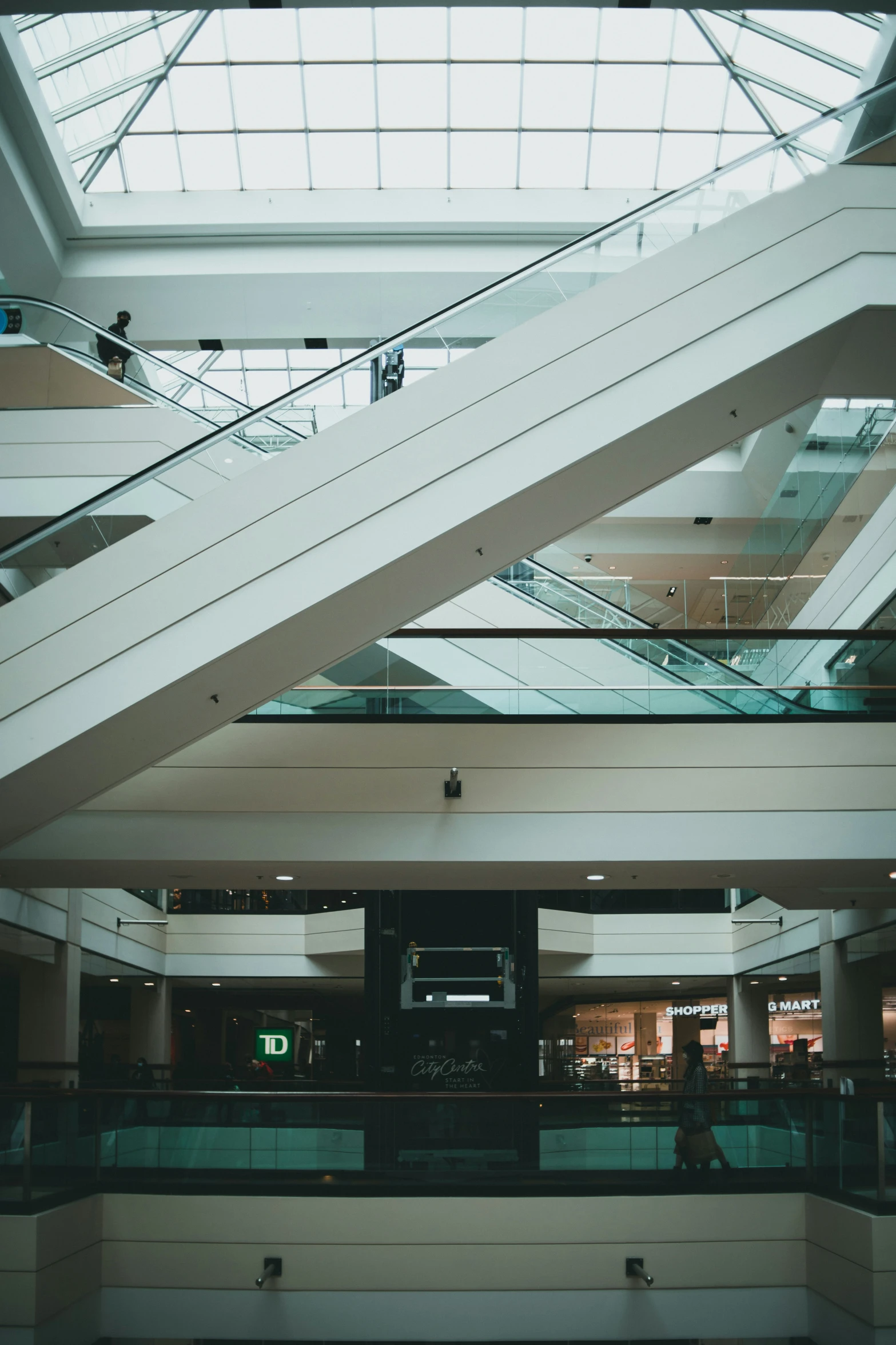 a lobby in an upscale mall with glass ceiling