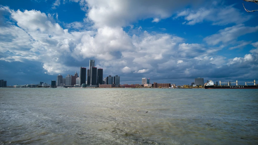 there is a body of water with a city in the background