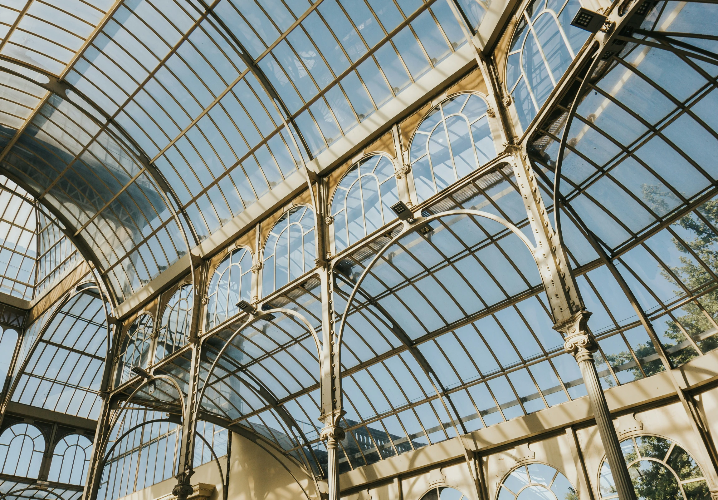 a large glass roof structure with several light fixtures
