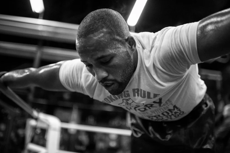 a man is hanging from the ropes in a boxing ring