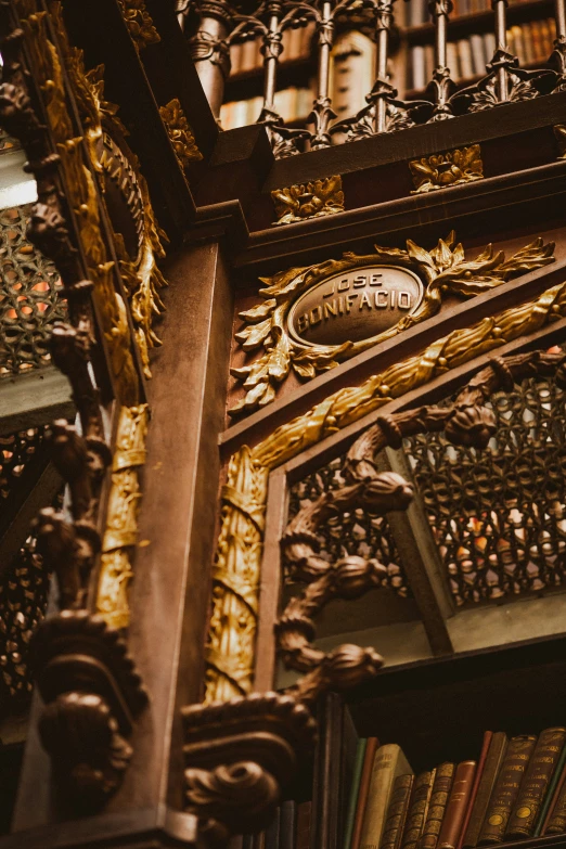 an ornate bookshelf with a gold and black emblem