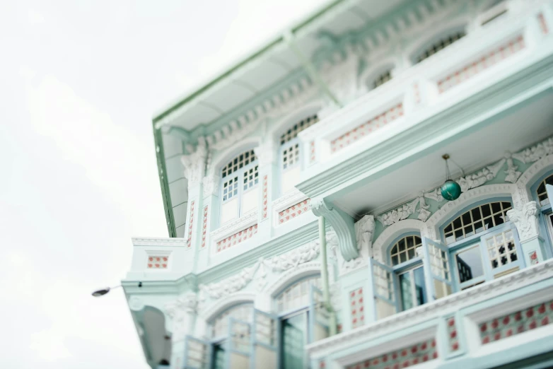 the facade of a white building with red trim