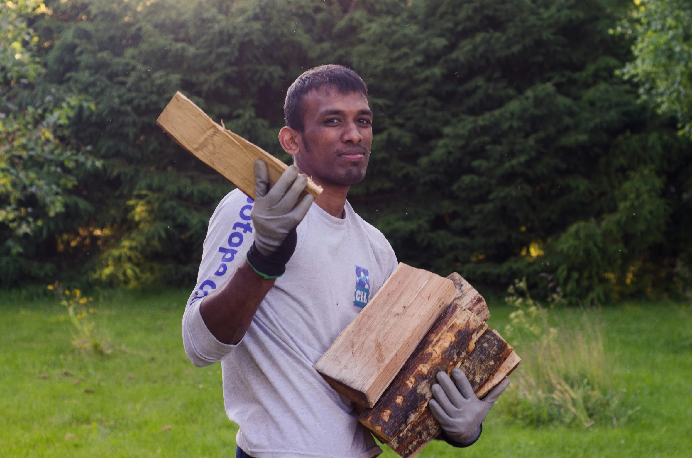 a man carrying bee boxes on his shoulder