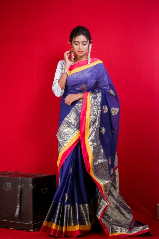 a woman in a sari is posing for a po