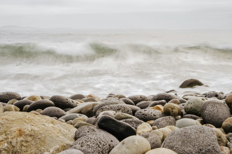 many rocks on the shore are covered with water